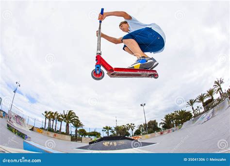 Boy Rides His Scooter At A Skate Park Royalty Free Stock Image Image