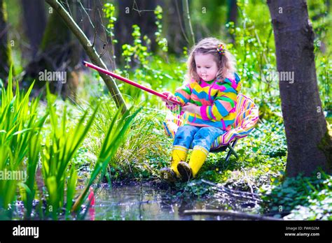 Child Playing Outdoors Preschooler Kid Catching Fish With Red Rod