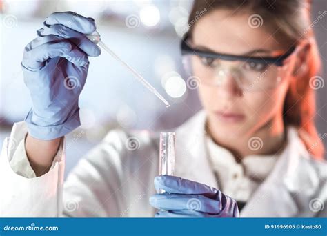 Young Scientist Pipetting In Life Science Laboratory Stock Image
