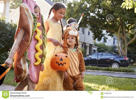 Children Wearing Halloween Costumes For Trick Or Treating Stock Photo