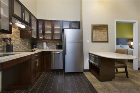 Guests will find kitchenettes with fridges, hobs, microwaves and dishwashers. Staybridge Suites Orlando near SeaWorld suite kitchen ...