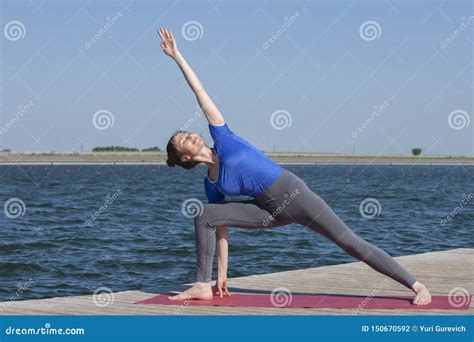 Pretty Woman Practicing Yoga At A Lake Stock Photo Image Of Health