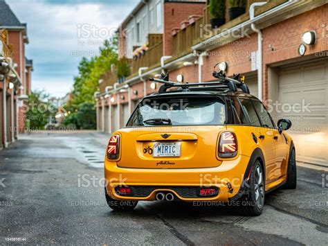 Orange mini cooper in the city neighbourhood stock photo
