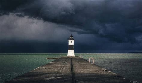 Storm Clouds Over The North Pier Lighthouse Storm Lake Beaches In