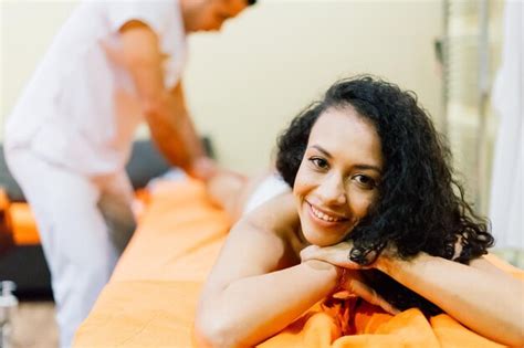 Premium Photo An Attractive Latin American Woman Lying Down On A Massage Bed At A Spa