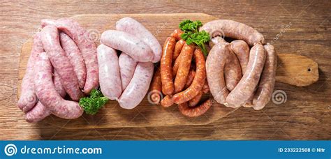 Various Kind Of Types Of Fresh Sausages On Chopping Board Stock Photo