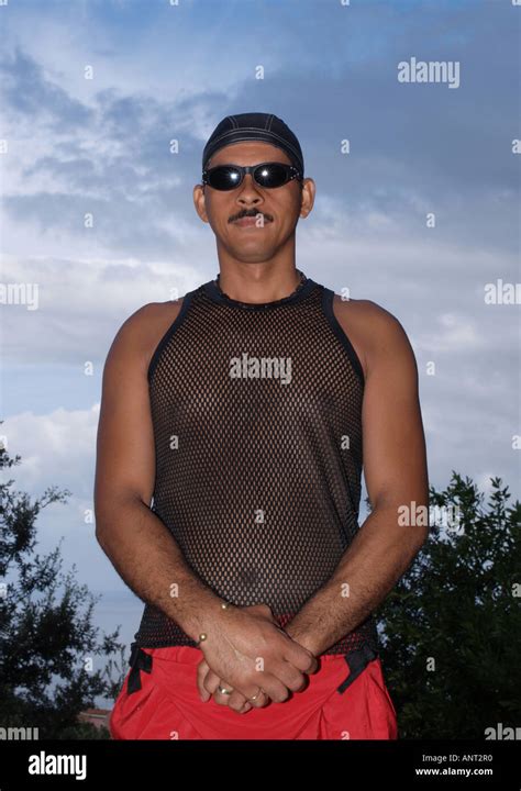 Man Wearing Black String Vest And Sunglasses Looking At Camera Stock