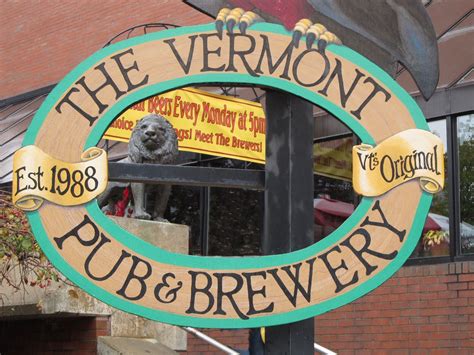 A Sign For The Vermont Pub And Brewery In Front Of A Brick Building