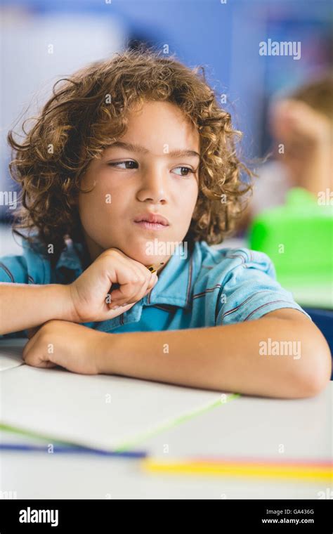 Close Up Of Thoughtful Boy Looking Away While Studying Stock Photo Alamy