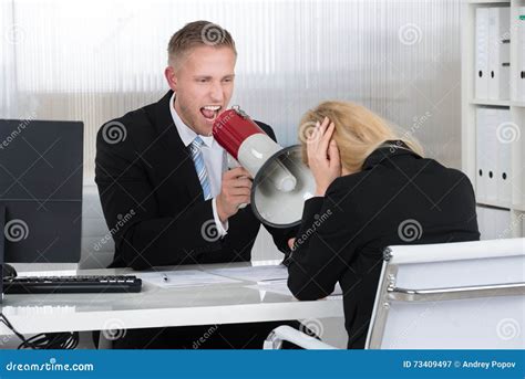 Boss Shouting At Businesswoman Through Loudspeaker In Office Stock