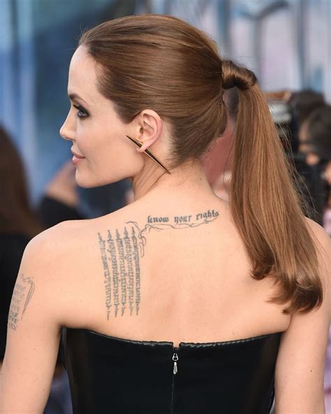A Woman With A Tattoo On Her Back