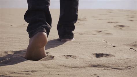 male feet walking on sand stock video footage storyblocks