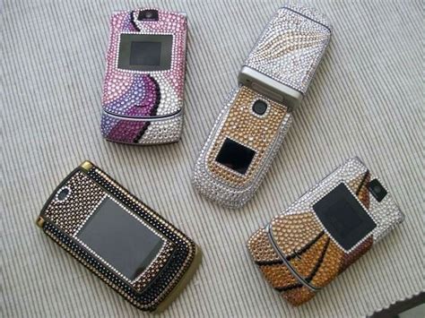 Four Cell Phones With Different Designs On Them Sitting Next To Each