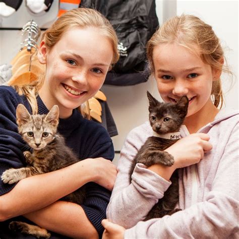 Two Young Girls Holding Kittens At Best Friends Event Animal Society