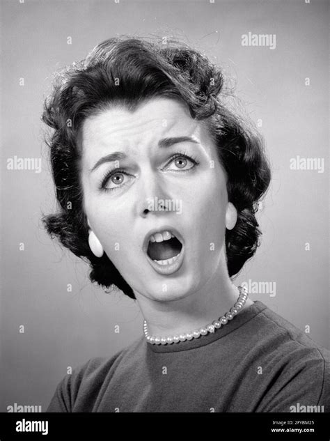 1950s 1960s Brunette Woman Mouth Open Angry Upset Shocked Alarmed Facial Expression Wearing