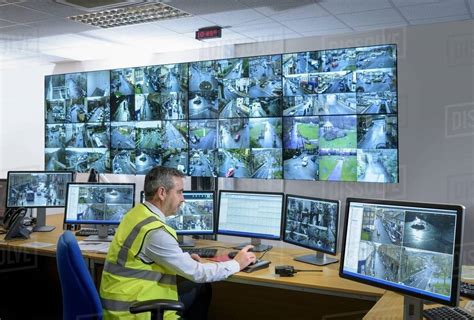 Security Guard In Security Control Room With Video Wall Stock Photo