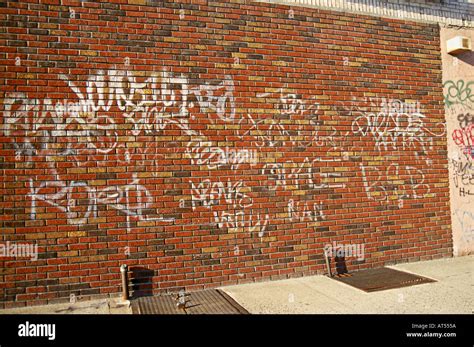 Shot Of Brick Wall With Graffiti Written On It Brooklyn New York Stock