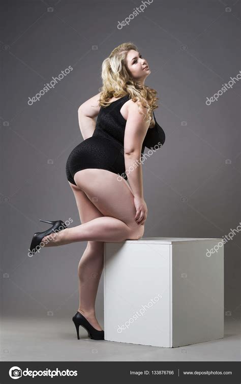 Young Beautiful Blonde Plus Size Model In Shapewear Xxl Woman In Slimming Underwear On Gray