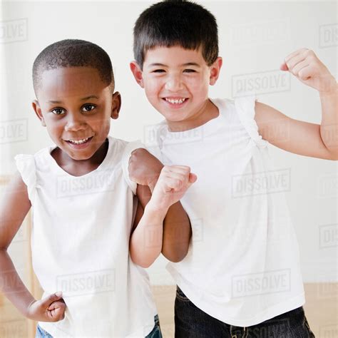 Smiling Boys Flexing Biceps Stock Photo Dissolve