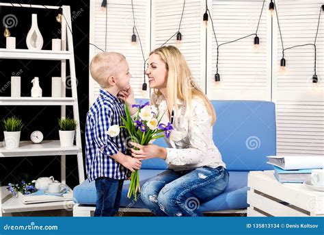 Son Congratulates His Beloved Mother And Gives Her A Bouquet Of Tulipsthe Concept Of The