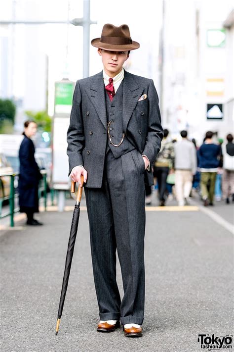 japanese guy showcasing a dapper retro suit street style while out and about in harajuku