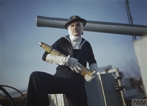 A Naval Gunner Wearing Anti Flash Gear Holding A Shell Royal Navy
