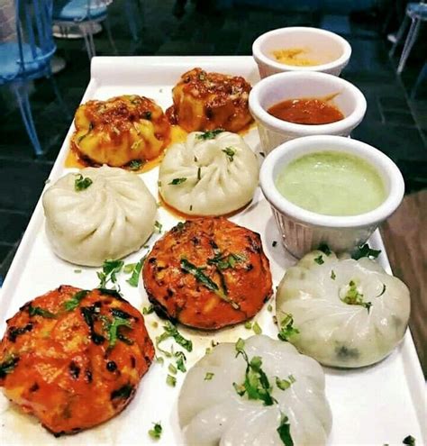 There Are Many Different Types Of Food On The Tray Including Dumplings