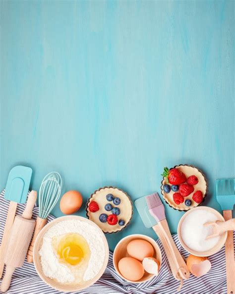 An Overhead View Of Kitchen Utensils And Food On A Blue Tablecloth With