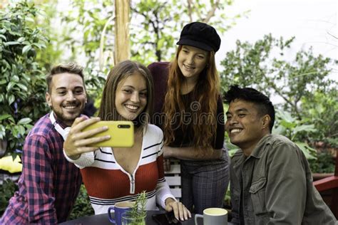 Multicultural Happy Friends Having Fun Taking Group Selfie Portrait Outside In The Garden During