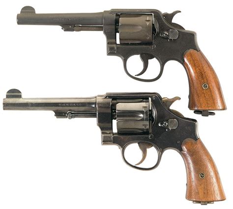 Two Smith And Wesson Double Action Revolvers A Smith And Wesson Victory