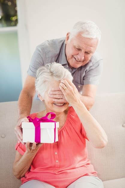 Premium Photo Senior Man Covering Senior Womans Eyes While Giving Her