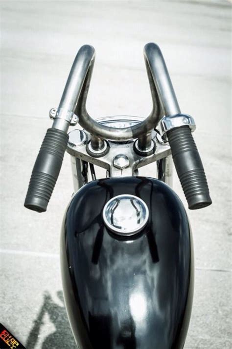 The Handlebars And Front End Of A Black Motorcycle