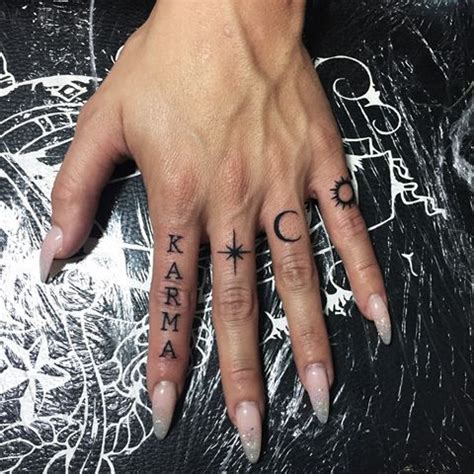 A Woman S Hand With Two Small Tattoos On It And The Word Karma Written