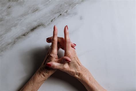 Persons Hand On White Surface · Free Stock Photo