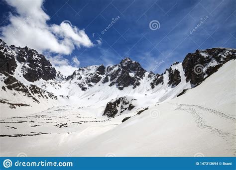 Snowy Sunlight Mountains And Cloudy Blue Sky Stock Photo Image Of