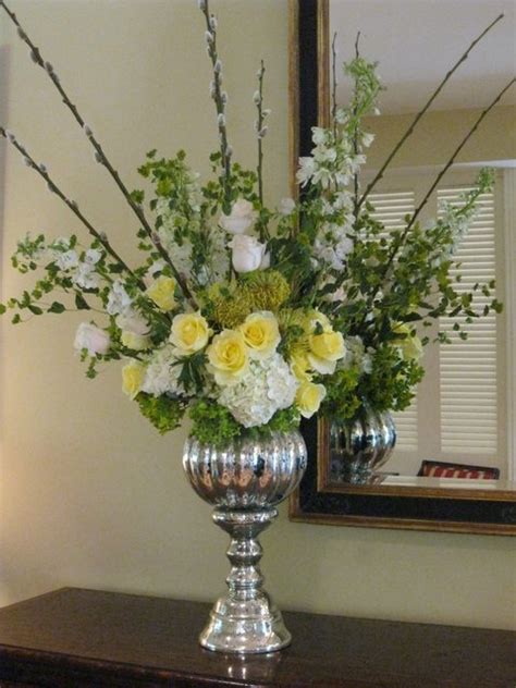 Wedding anniversaries have used specific types of flowers to grace the event. Entry hall arrangement with Mercury glass container for ...