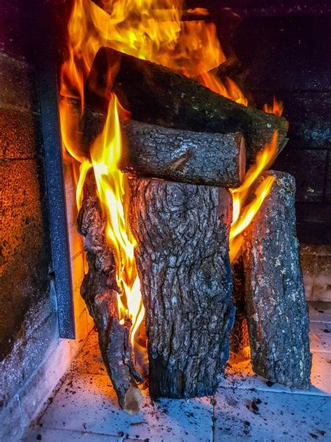 Burning Firewood In The Fireplace Closeup Glowing Logs Fire And