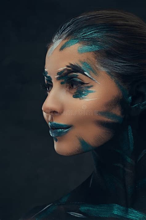 A Young Sensual Girl With Creative Make Up Blue And Black Shadows