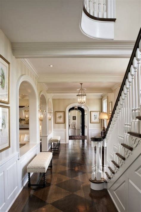 An Elegant Foyer With White Walls And Wood Flooring