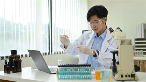 Male Research Scientist Is Conducting Experiment In Laboratory