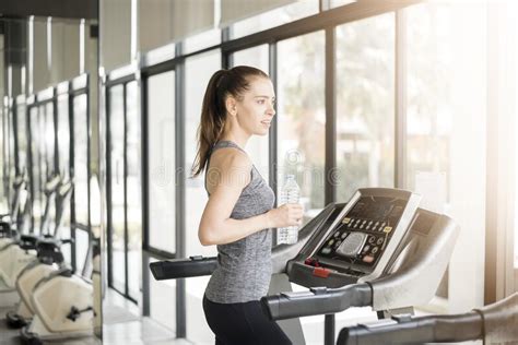 Pretty Young Sport Woman Is Drinking Water On Treadmill In Gym Healthy