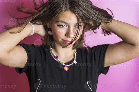 Portrait Of A Beautiful Caucasian Girl Shaking Her Hair Posing On A Pink Background 18903113