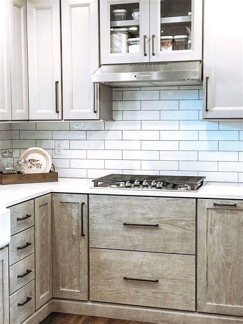Modern Farmhouse Kitchen With White Subway Tile Painted Upper Cabinets
