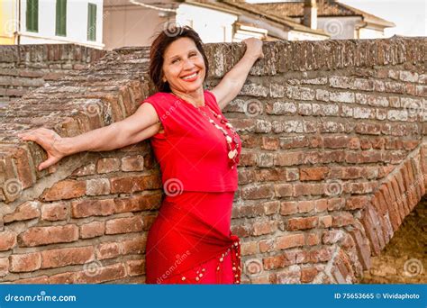 mature woman in typical town in italy stock image image of woman leaning 75653665