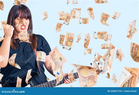Young Plus Size Woman Playing Electric Guitar Annoyed And Frustrated