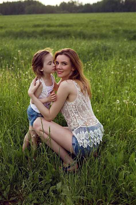 Mom And Daughter Are Sitting In A Green Field Photograph By Elena Saulich Fine Art America