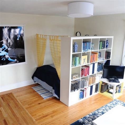 A Room With A Bed Bookshelf And Pictures On The Wall In It