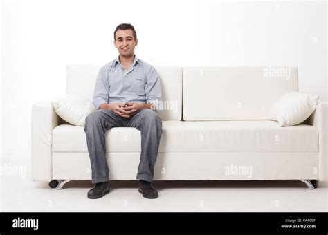 Young Man Sitting On A Modern Sofa Stock Photo Alamy