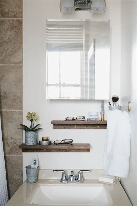 A Bathroom With A Sink Mirror And Towel Rack