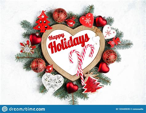 Happy Holidays Text With Holiday Evergreen Branches Frame In The Shape